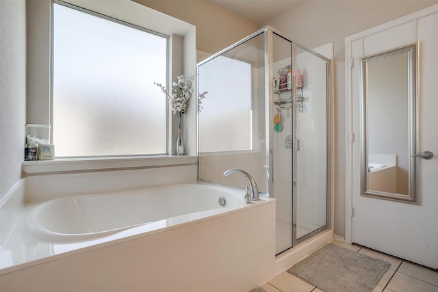 bathroom featuring tile patterned flooring and shower with separate bathtub