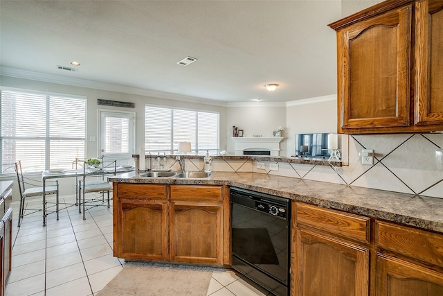 kitchen with kitchen peninsula, sink, light tile patterned flooring, black dishwasher, and ornamental molding