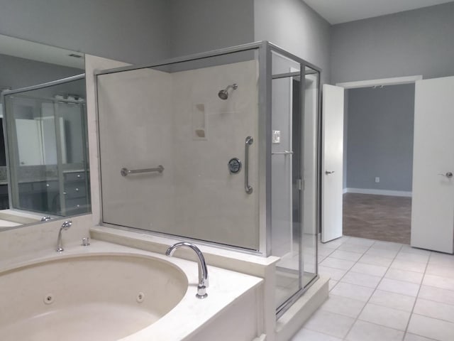 bathroom featuring tile patterned floors and shower with separate bathtub