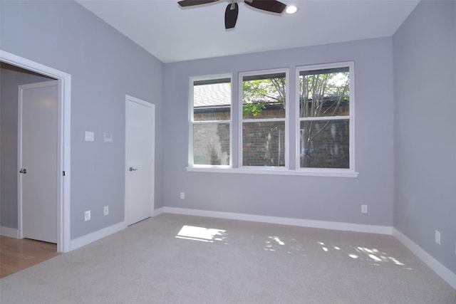 carpeted empty room with ceiling fan