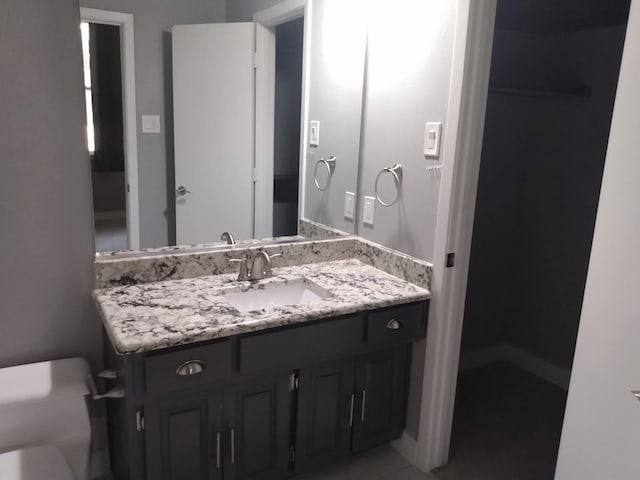 bathroom featuring toilet and vanity