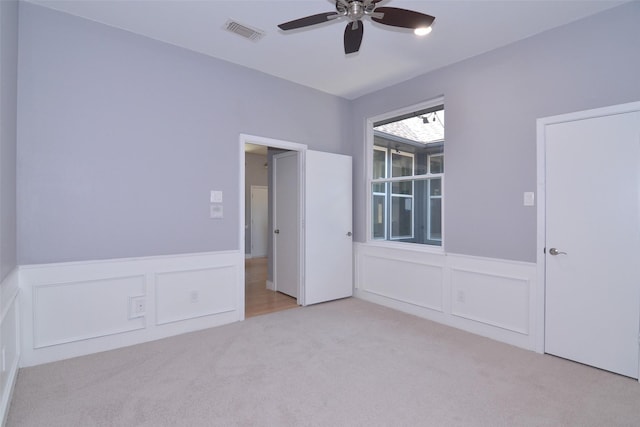 unfurnished bedroom featuring ceiling fan and light carpet