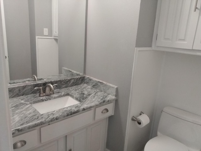 bathroom featuring toilet and vanity