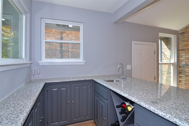 kitchen with sink and light stone counters