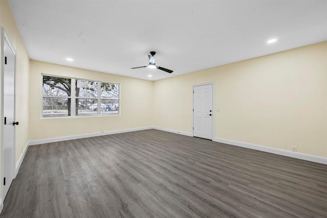 empty room with ceiling fan and dark hardwood / wood-style floors