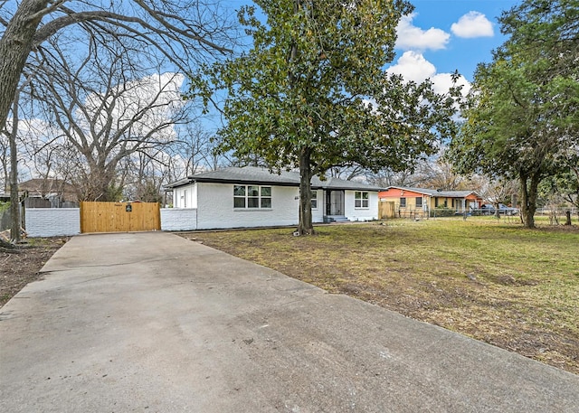 ranch-style home with a front lawn