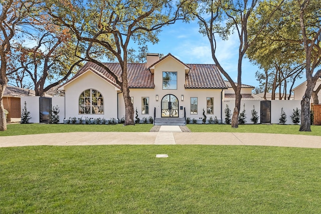 mediterranean / spanish home featuring a front lawn