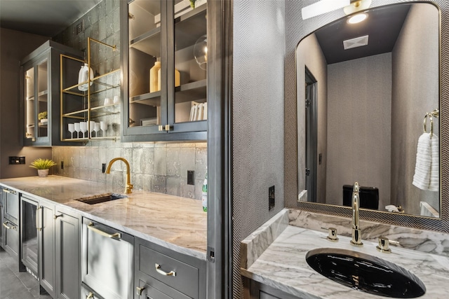 kitchen with sink and light stone countertops