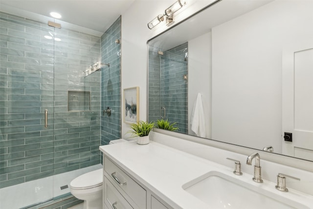 bathroom featuring toilet, an enclosed shower, and vanity