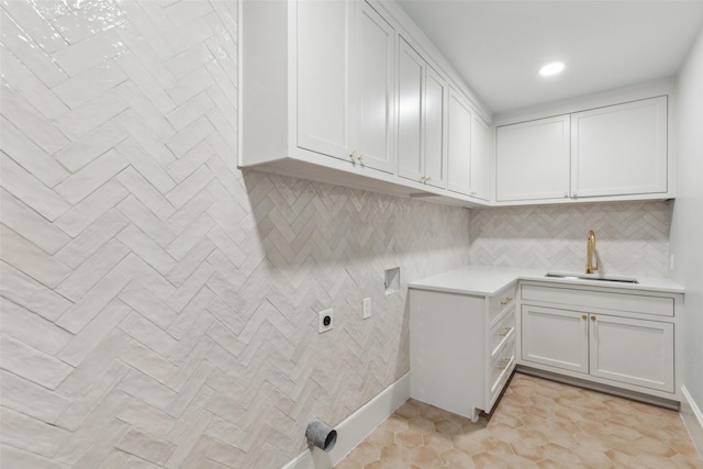 laundry room featuring cabinets, washer hookup, sink, hookup for an electric dryer, and light tile patterned floors