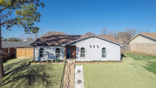 ranch-style home with a front lawn