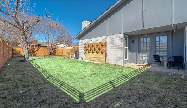 view of yard with a patio area and french doors