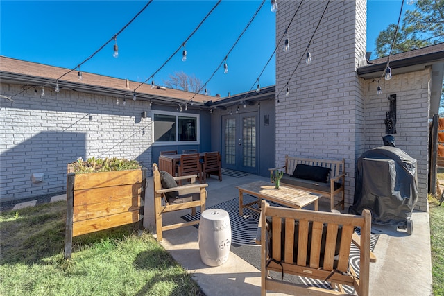 view of patio / terrace with area for grilling, an outdoor hangout area, and french doors