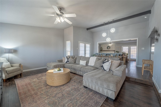 living room featuring ceiling fan, a wealth of natural light, and dark hardwood / wood-style flooring