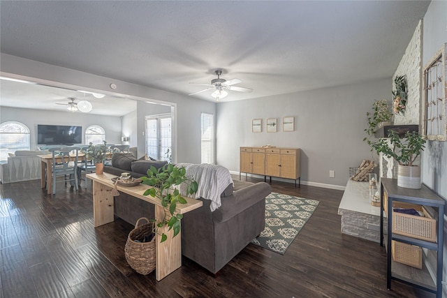 living room featuring ceiling fan and dark hardwood / wood-style flooring