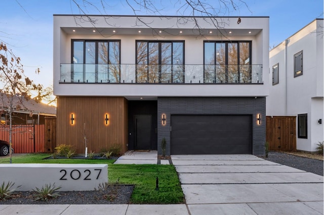 modern home with a garage and a balcony