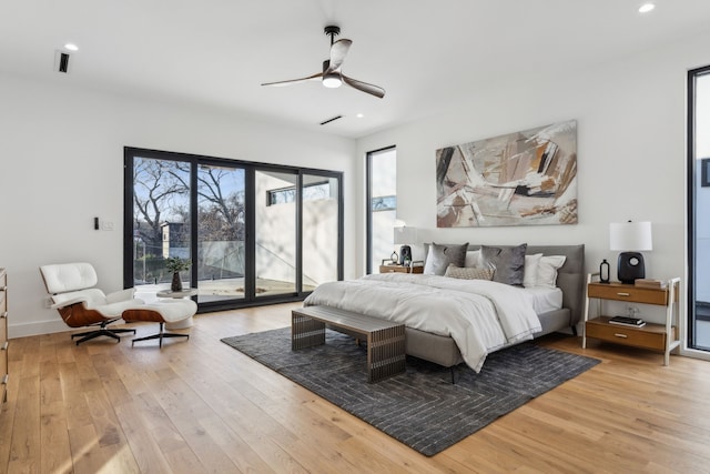 bedroom with light hardwood / wood-style flooring, access to outside, and ceiling fan