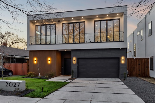 modern home featuring a garage and a balcony