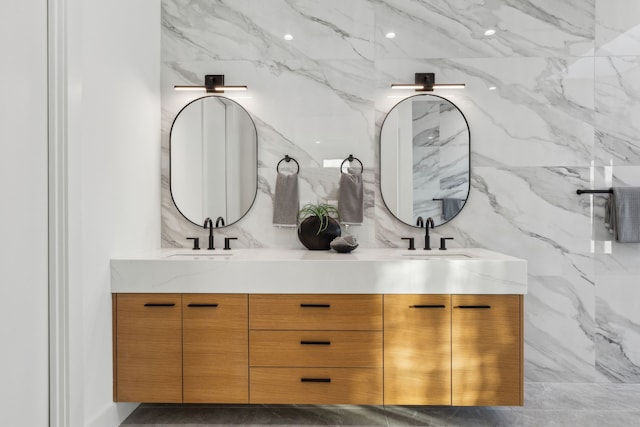 bathroom featuring vanity and tile walls