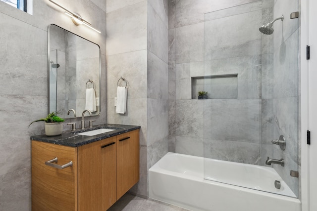 bathroom featuring shower / tub combination, tile walls, and vanity