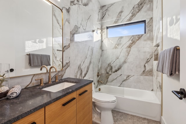 full bathroom featuring tiled shower / bath, vanity, and toilet