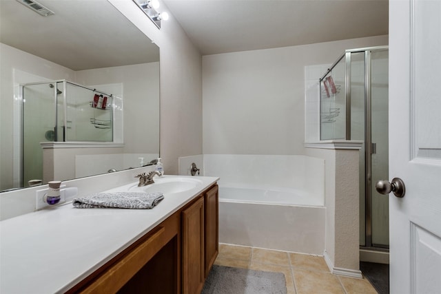 bathroom featuring vanity, shower with separate bathtub, and tile patterned flooring