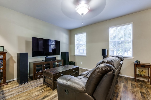 living room featuring light hardwood / wood-style floors and ceiling fan