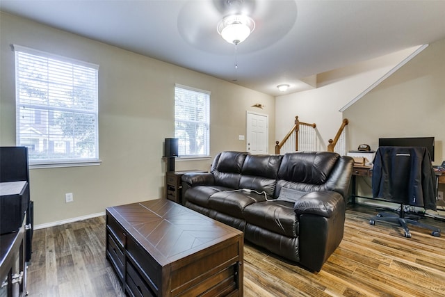 living room featuring ceiling fan, hardwood / wood-style floors, and a healthy amount of sunlight