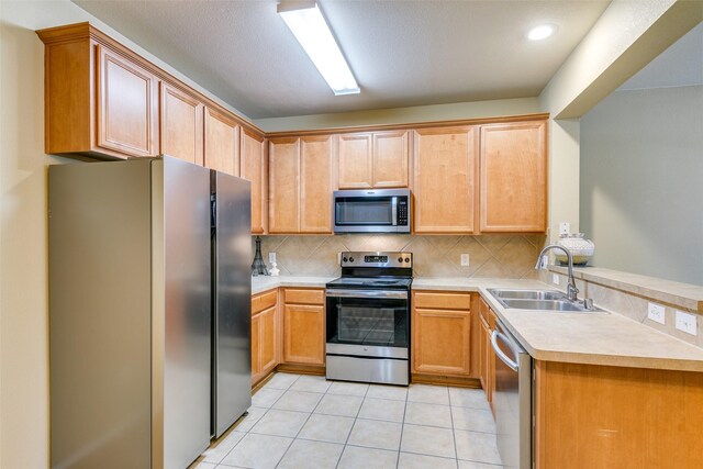 kitchen featuring decorative light fixtures, sink, a chandelier, light tile patterned floors, and stainless steel dishwasher