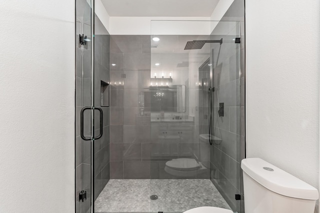 bathroom with toilet and an enclosed shower