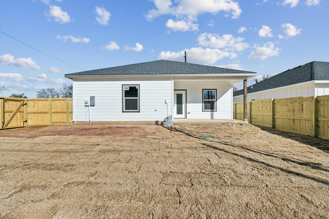 rear view of property with a yard