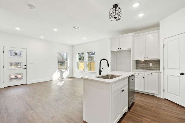 kitchen featuring an island with sink, wood-type flooring, sink, and white cabinets