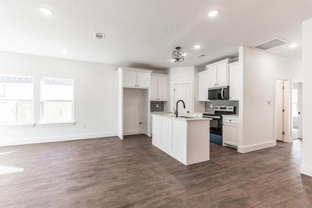 kitchen featuring sink, white cabinetry, a center island with sink, electric range, and decorative backsplash