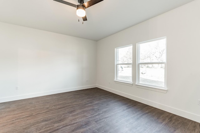 empty room with dark wood-type flooring and ceiling fan