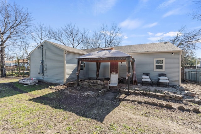 back of house featuring a gazebo and a yard