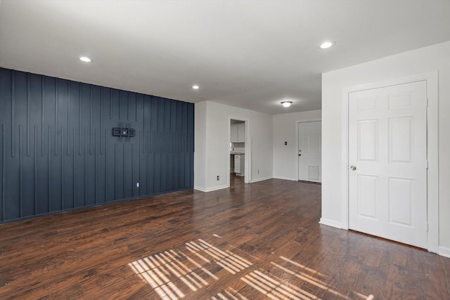 unfurnished room with dark wood-type flooring