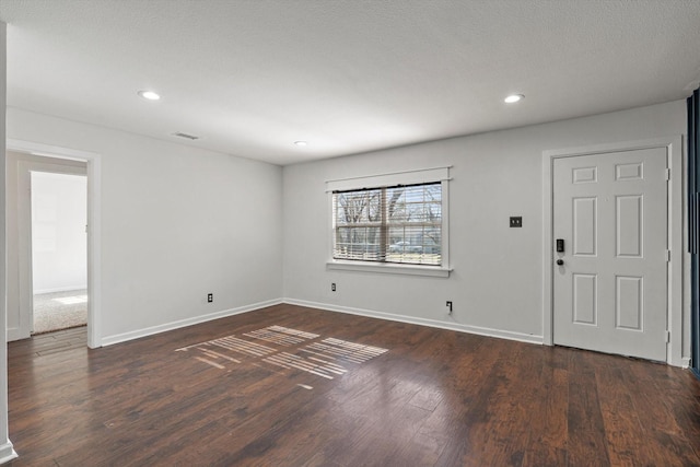 empty room with dark wood-type flooring