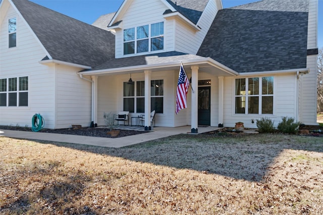 view of front of house featuring covered porch and a front yard