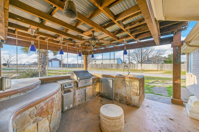 view of patio with sink, an outdoor kitchen, and grilling area