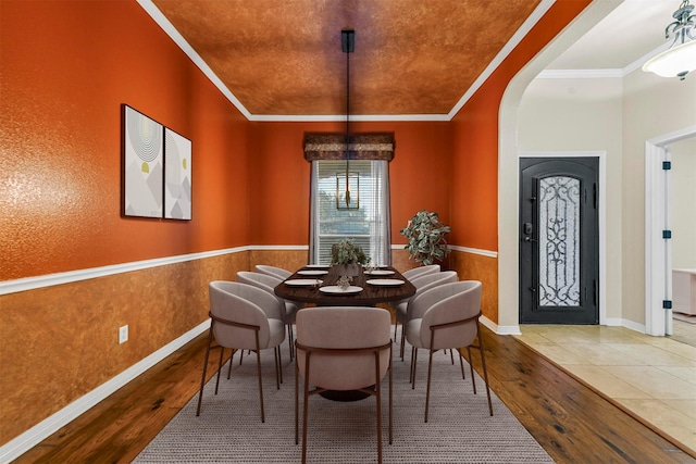 dining room with ornamental molding and hardwood / wood-style floors