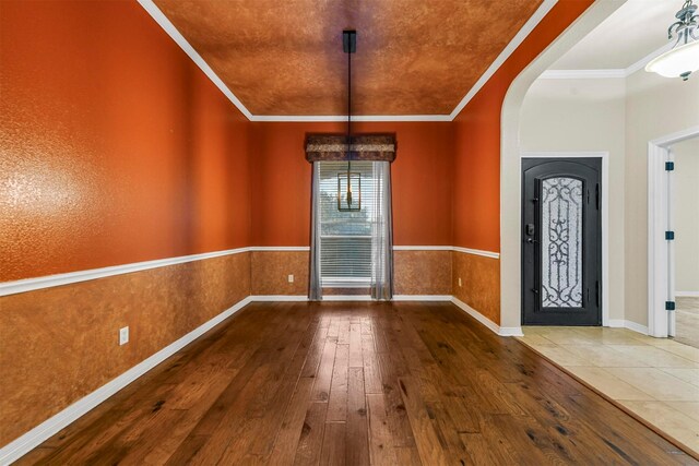 entryway featuring ornamental molding and hardwood / wood-style floors