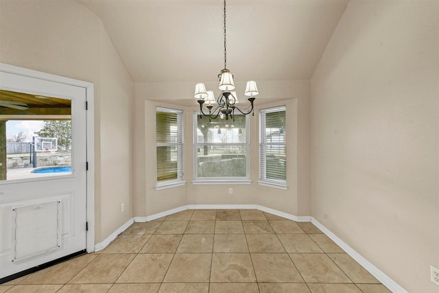 unfurnished dining area with plenty of natural light, light tile patterned flooring, and lofted ceiling