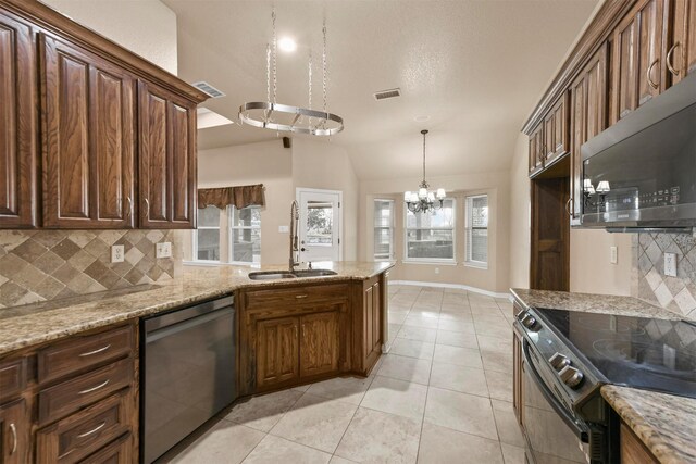 kitchen featuring dishwasher, decorative light fixtures, vaulted ceiling, light tile patterned floors, and electric range oven