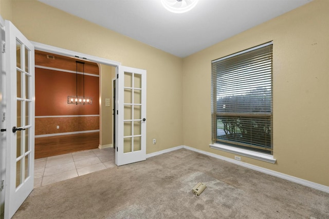 carpeted empty room with french doors