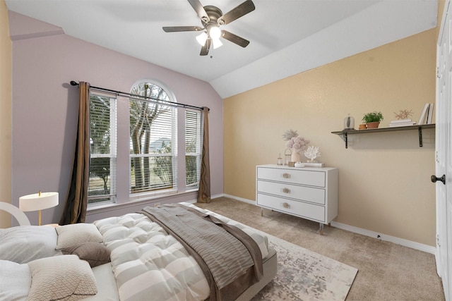 bedroom featuring light carpet, lofted ceiling, and ceiling fan