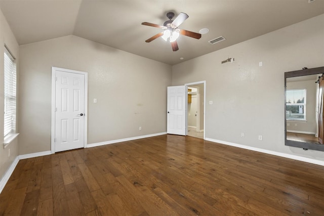 unfurnished bedroom with vaulted ceiling, dark hardwood / wood-style floors, and ceiling fan