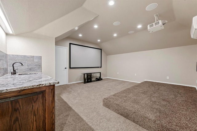 carpeted cinema with lofted ceiling and sink