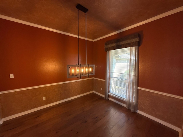 empty room with crown molding and dark hardwood / wood-style floors