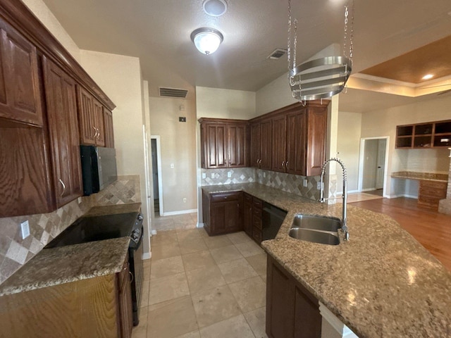 kitchen with light stone countertops, tasteful backsplash, sink, black electric range, and light tile patterned floors