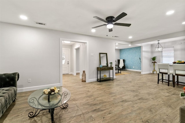 living room featuring ceiling fan and light wood-type flooring